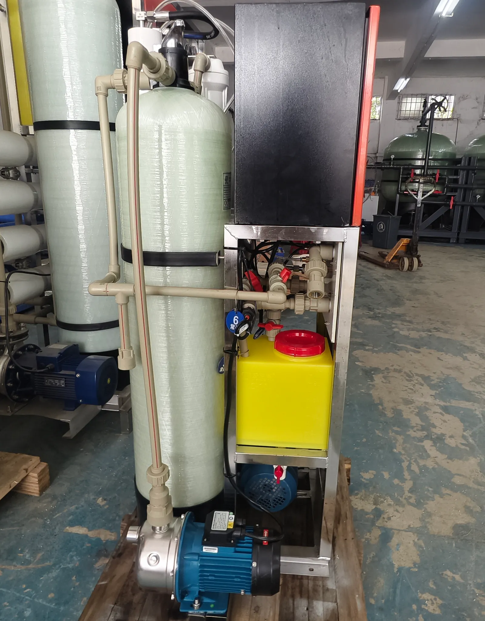 Small 0.5-tonne-per-day desalination unit with media vessels, dosing tank and pump