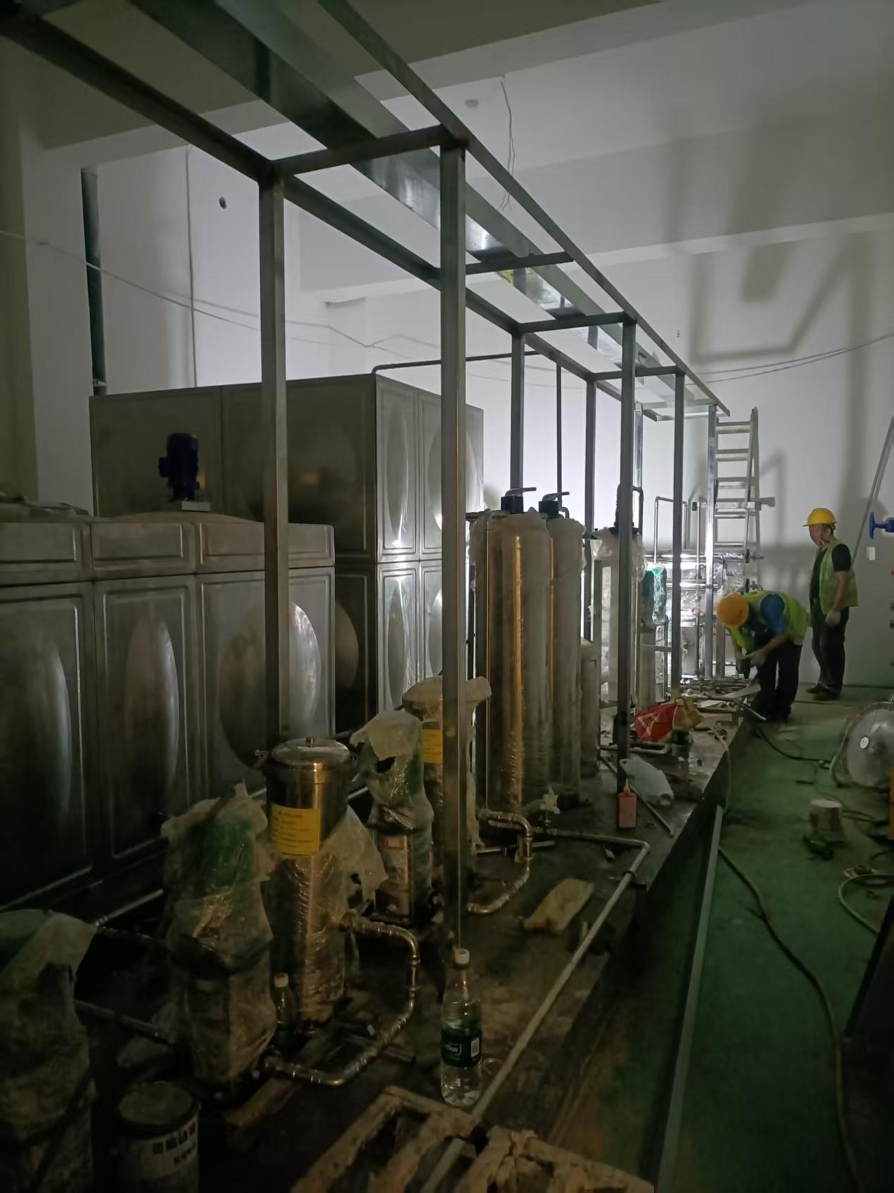 Installation overview of the campus rainwater-to-drinking-water system: stainless-steel frame, storage tanks and filter vessels in the equipment room
